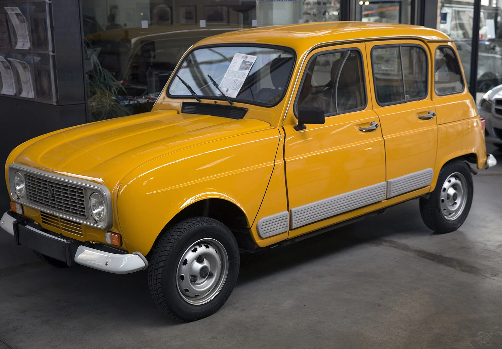 Yellow Renault 4 GTL hatchback photographed from the front three-quarter angle