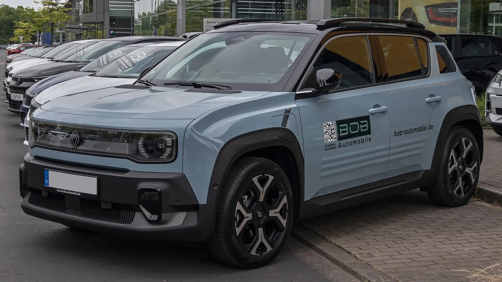 Pale blue Renault 4 E-Tech electric crossover photographed from the front three-quarter angle