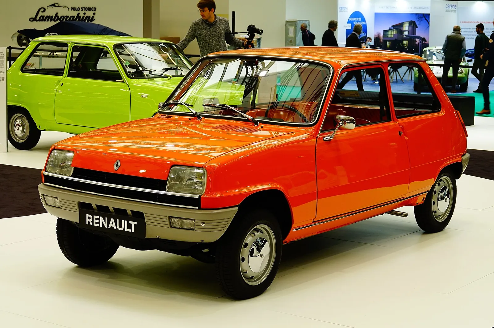 Red original Renault 5 hatchback photographed from the front three-quarter angle at a museum display