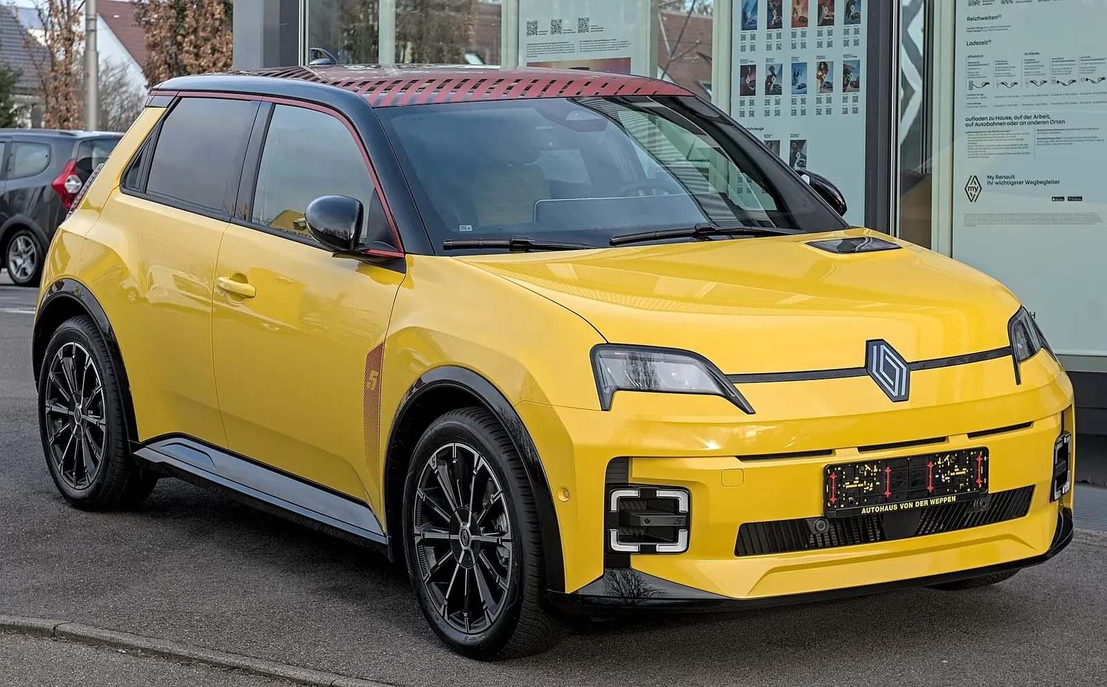 Yellow Renault 5 E-Tech electric hatchback photographed from the front three-quarter angle