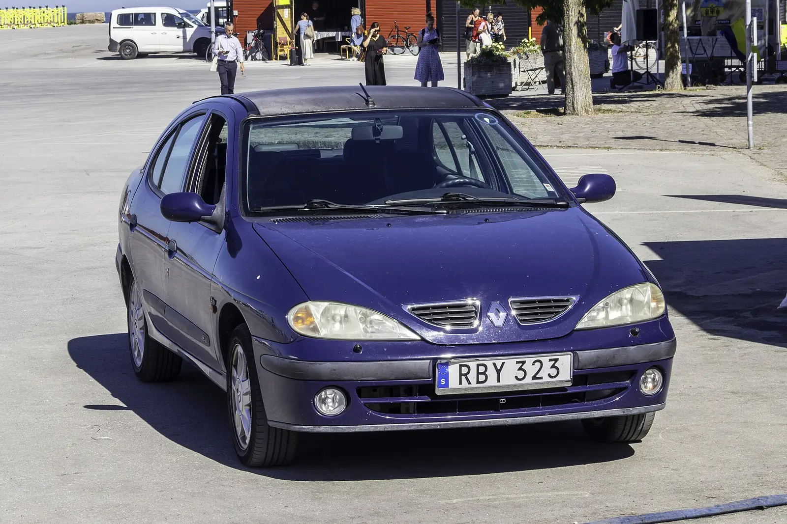 Yellow first-generation Renault Mégane Coupé 16V photographed from the front three-quarter angle inside a museum