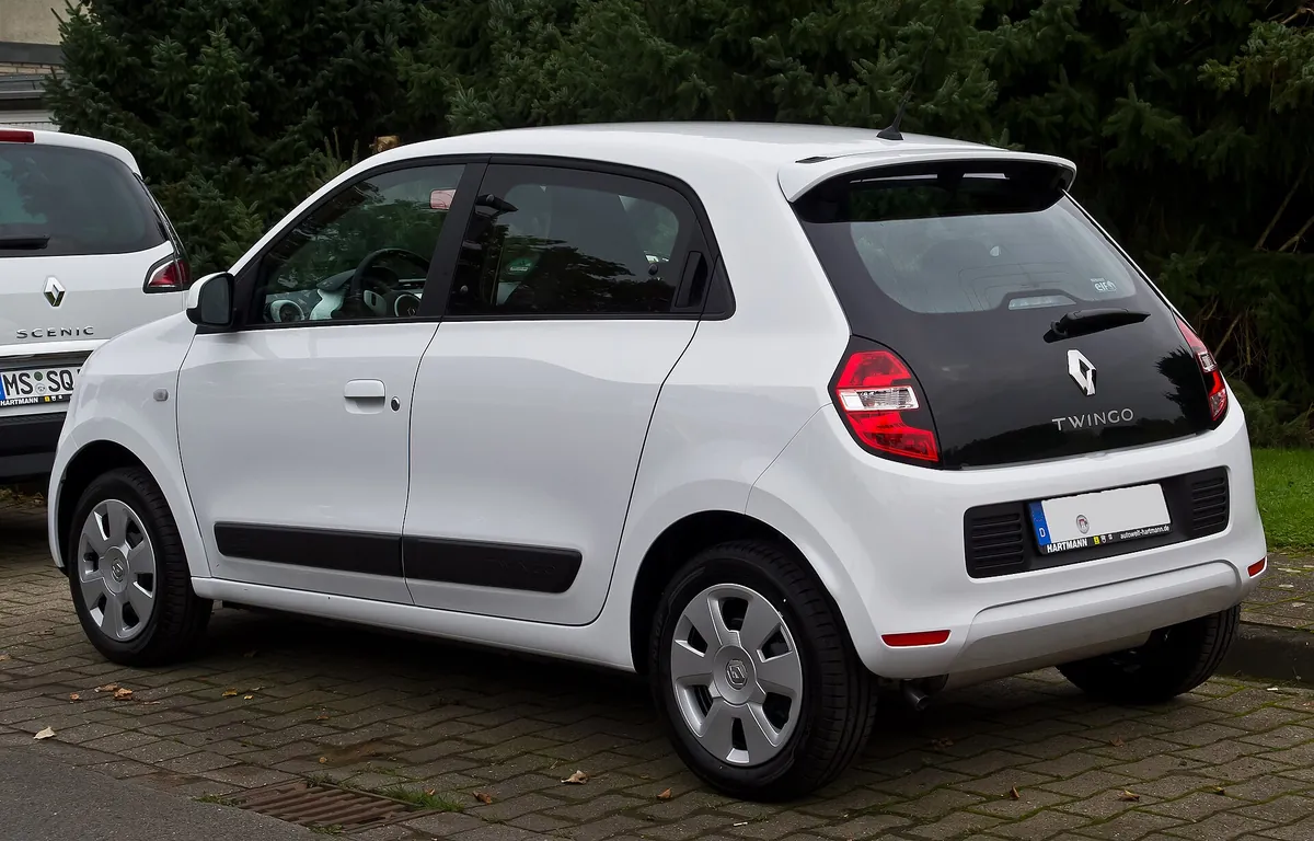 Rear three-quarter view of a white third-generation Renault Twingo showing the Twingo badge and split tail lamps