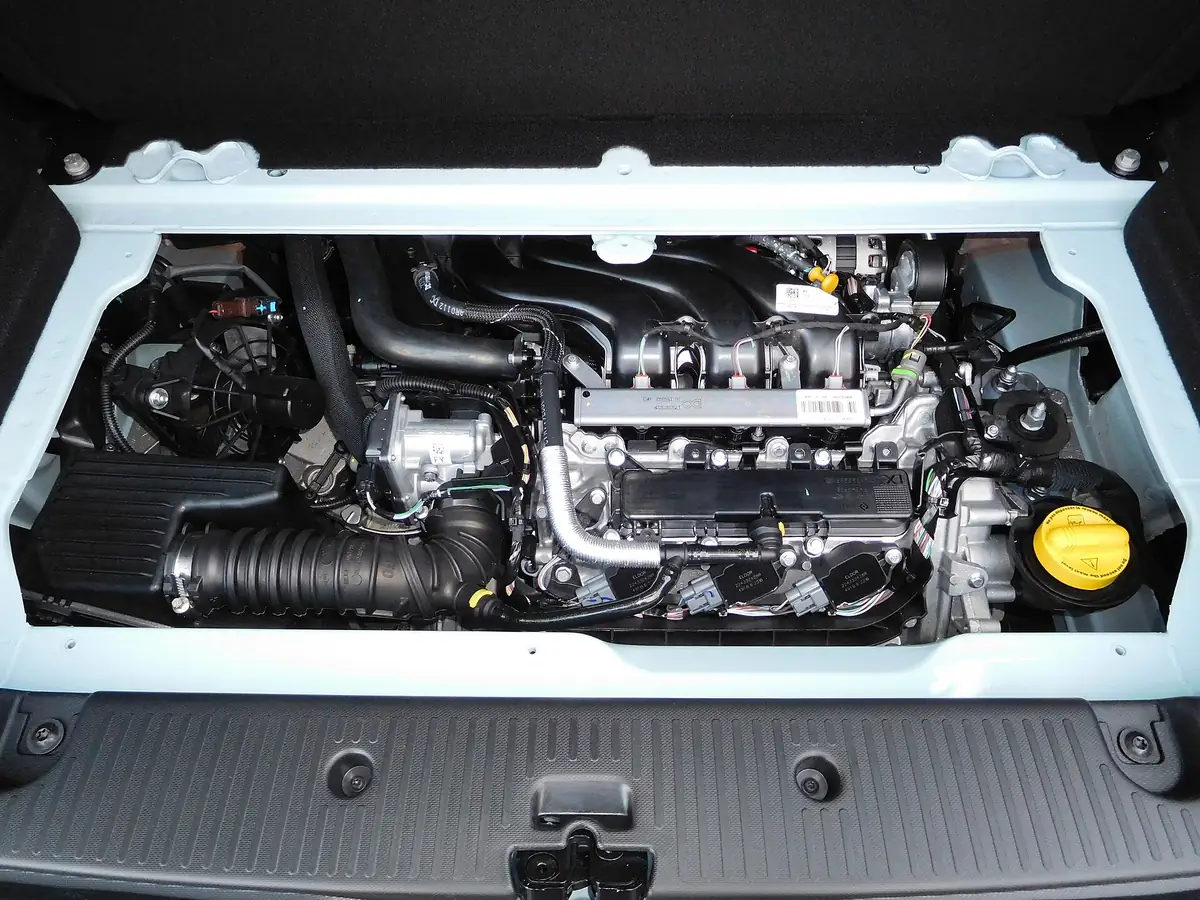 Rear luggage compartment of a third-generation Renault Twingo SCe 70 with the boot floor removed to show the transversely mounted three-cylinder engine beneath