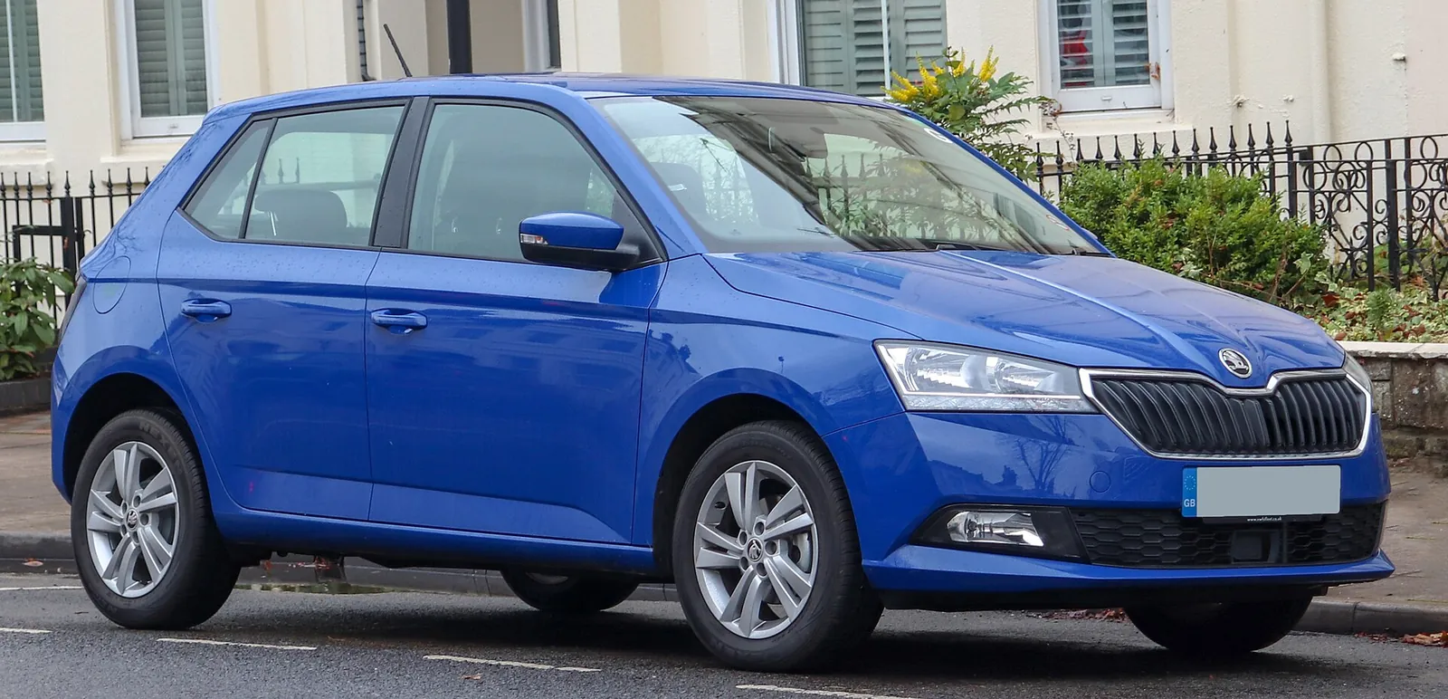 White facelifted third-generation Skoda Fabia hatchback photographed from the front three-quarter angle on a street