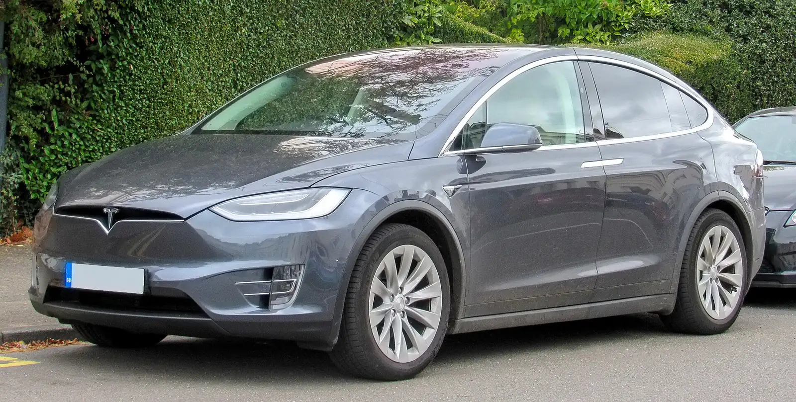 Grey Tesla Model X 100D photographed from the front three-quarter angle