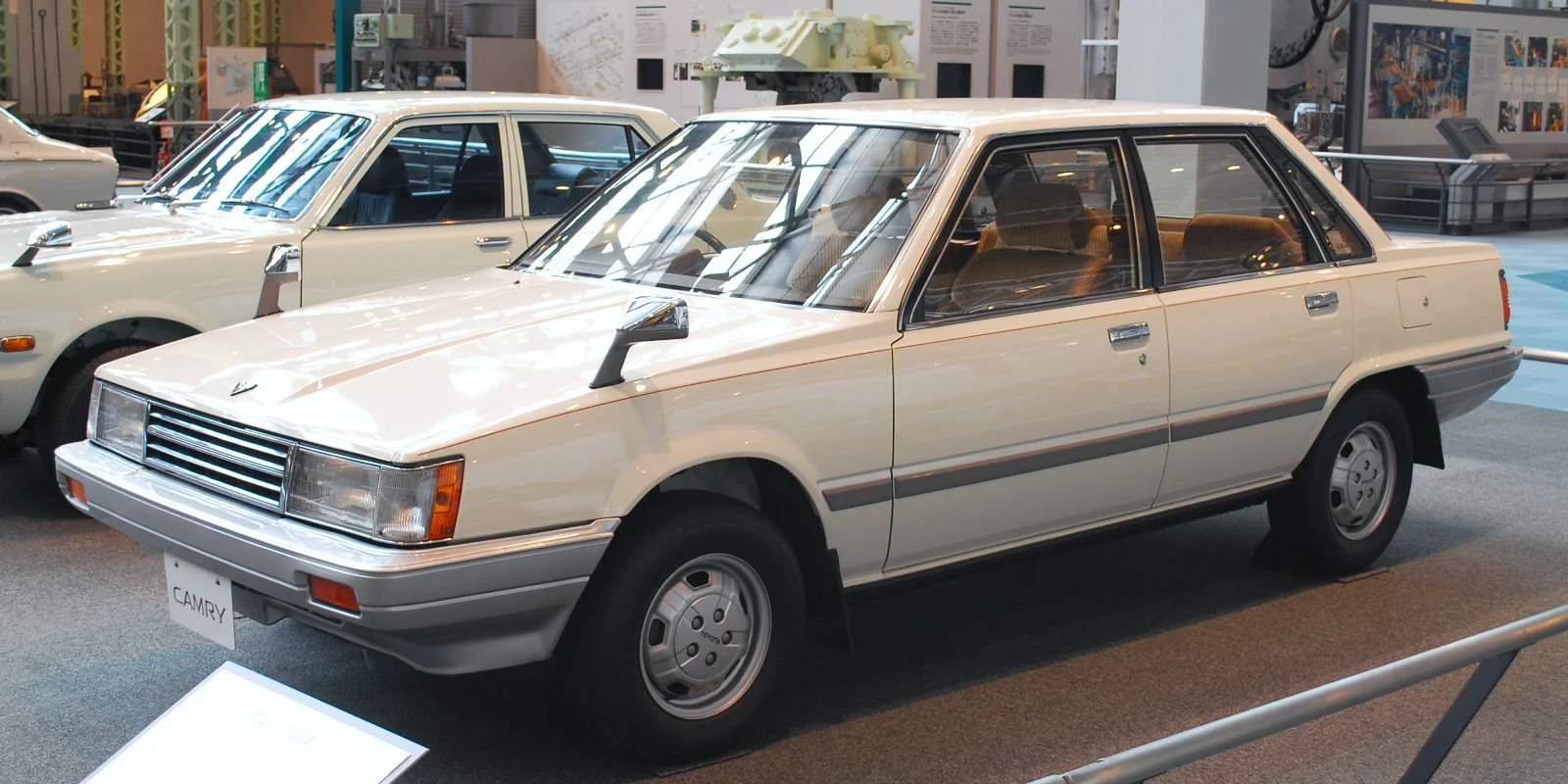 Cream first-generation Toyota Camry saloon photographed from the front three-quarter angle