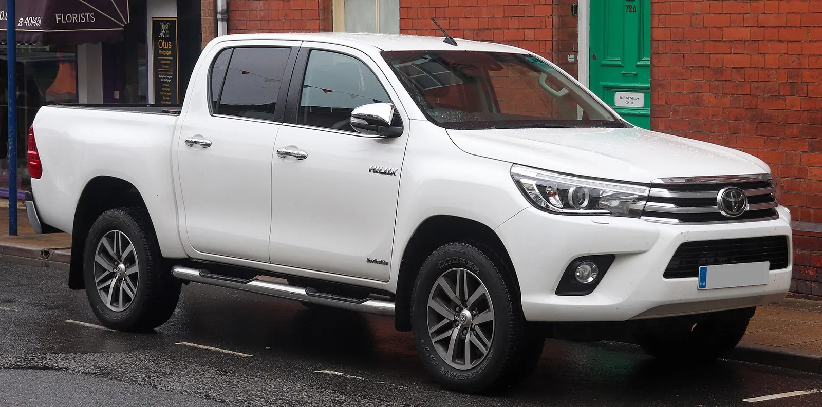 White Toyota Hilux Invincible double-cab pickup photographed from the front three-quarter angle