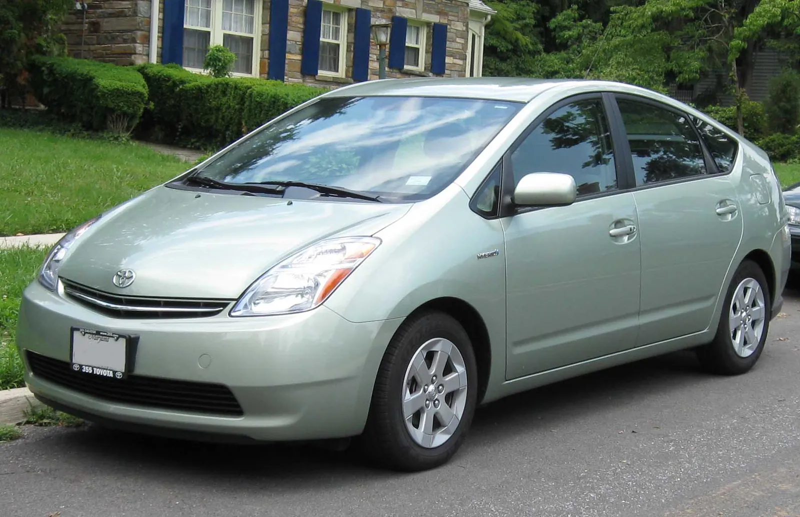 Silver second-generation Toyota Prius photographed from the front three-quarter angle, showing the wedge nose and steeply raked windscreen