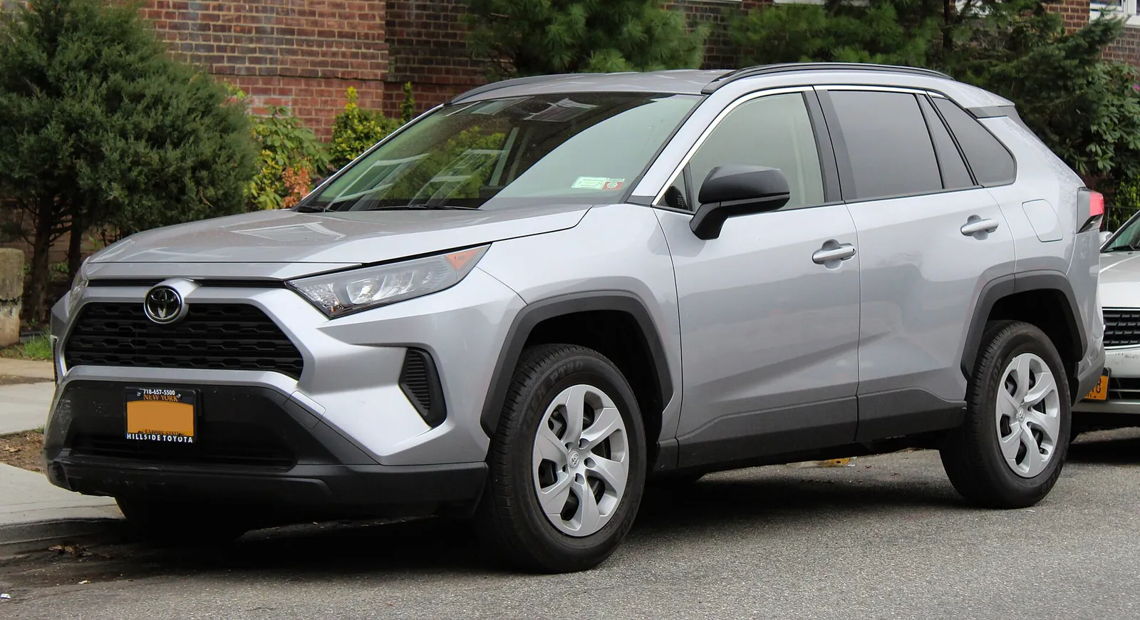 Grey fifth-generation Toyota RAV4 LE photographed from the front three-quarter angle