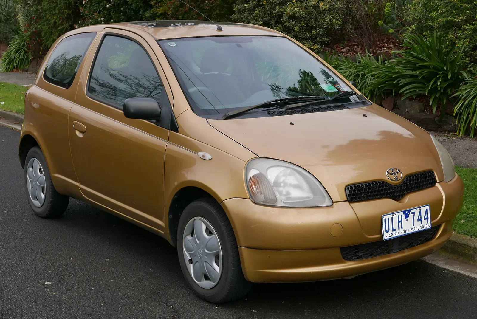 Gold 2000 Toyota Echo three-door hatchback photographed from the front three-quarter angle