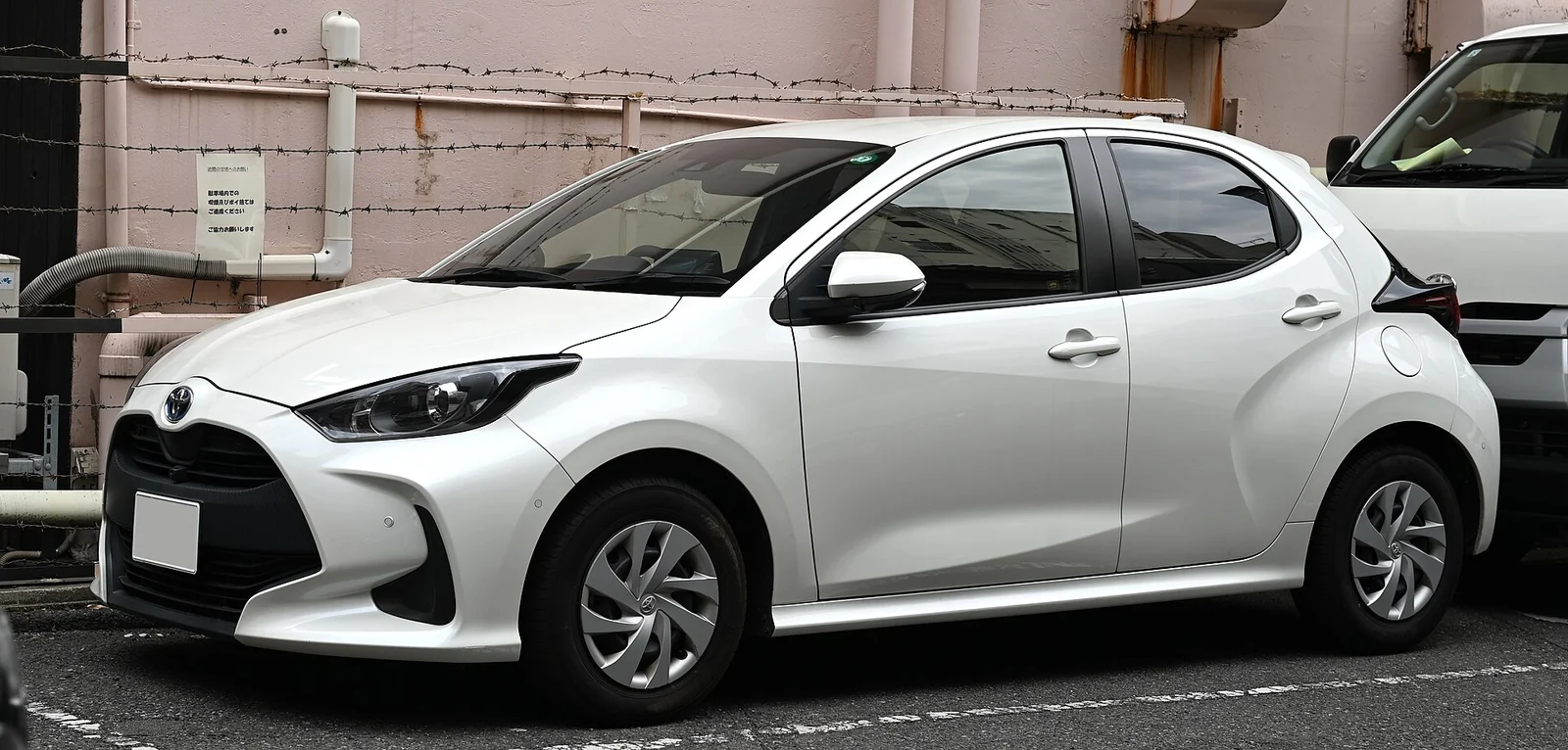 White Toyota Yaris Hybrid hatchback (XP210) photographed from the front three-quarter angle