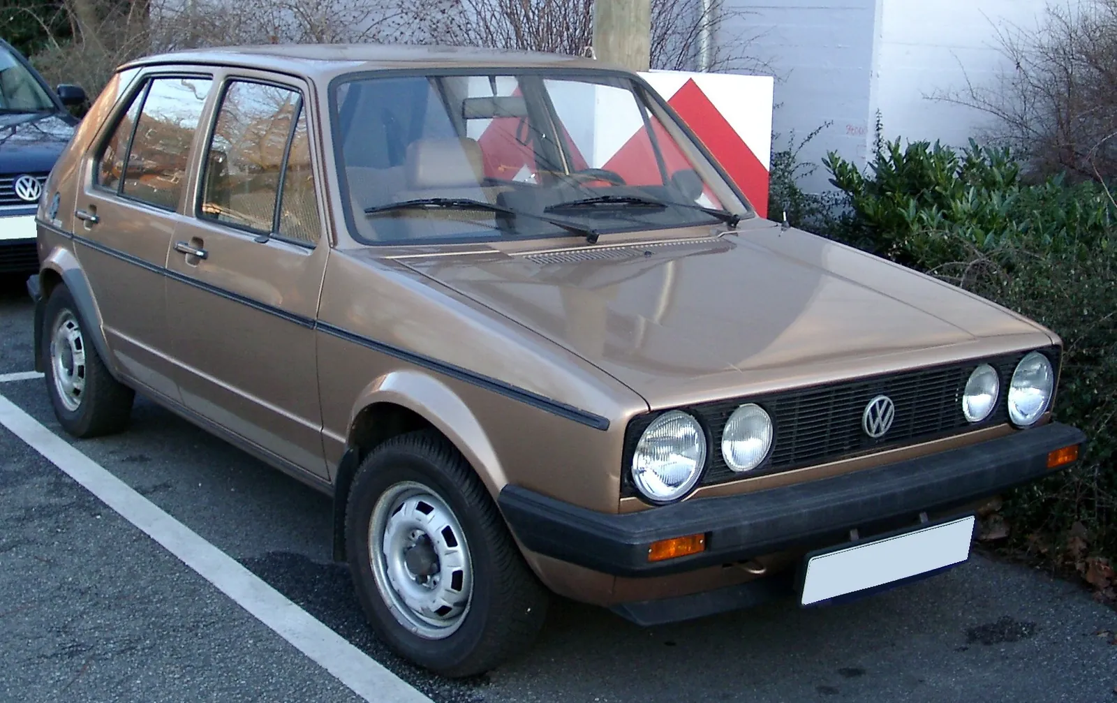 Red Volkswagen Golf Mk1 photographed head-on, showing the square headlamps, black grille and upright glasshouse