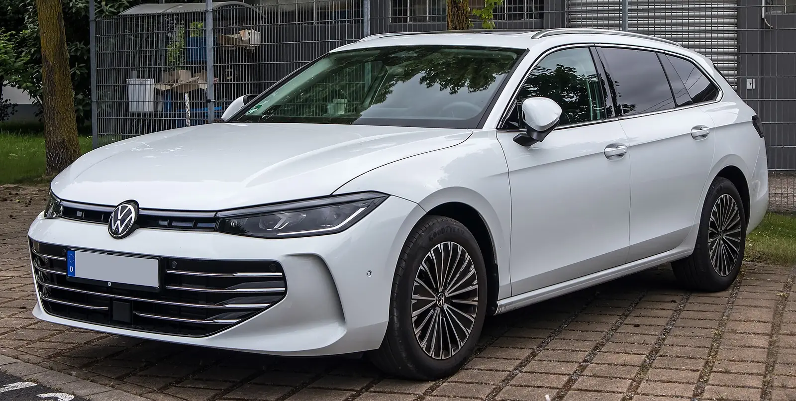 White 2025 Volkswagen Passat Variant Elegance estate photographed from the front three-quarter angle in a car park