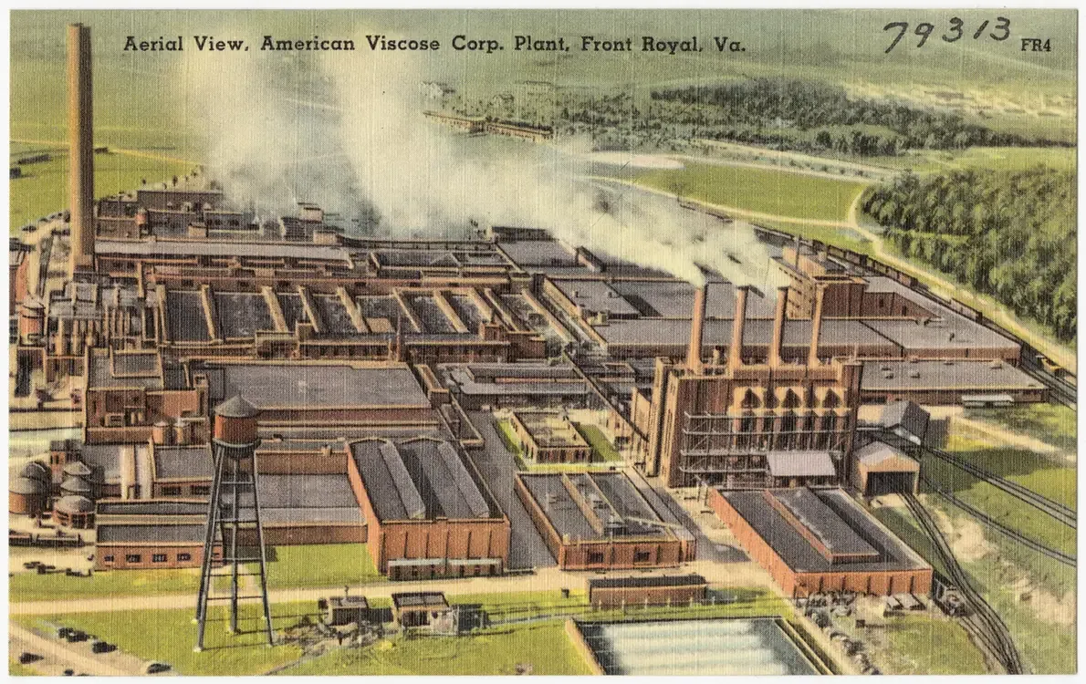 A tinted aerial postcard view of a sprawling factory complex with multiple long low buildings, tall smokestacks and cooling ponds, captioned 'Aerial View, American Viscose Corp. Plant, Front Royal, Va.'