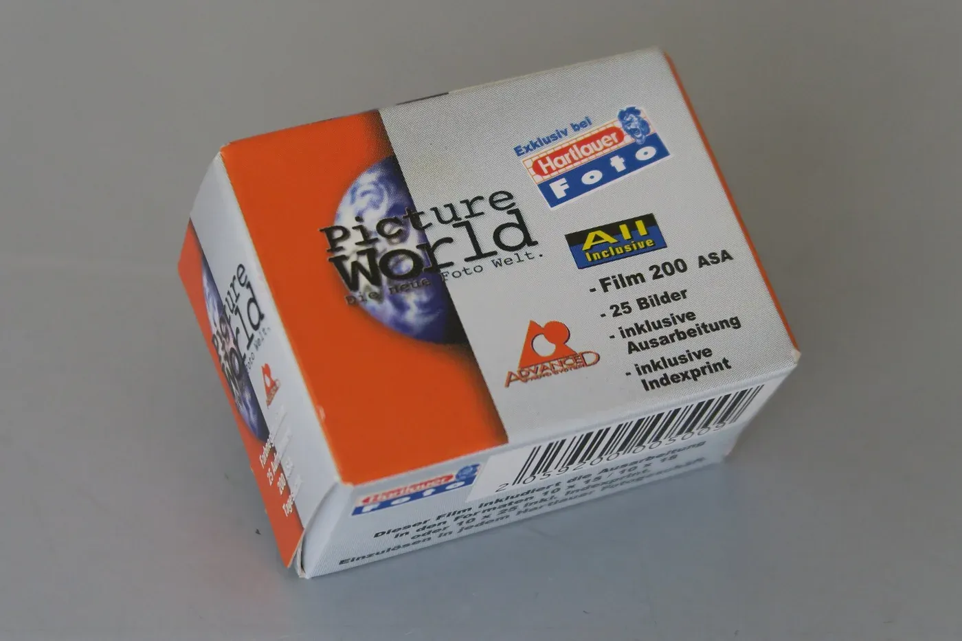 A small rectangular cardboard box of photographic film, printed 'Picture World' with an orange stripe and a blue globe graphic, photographed at an angle against a plain grey background.