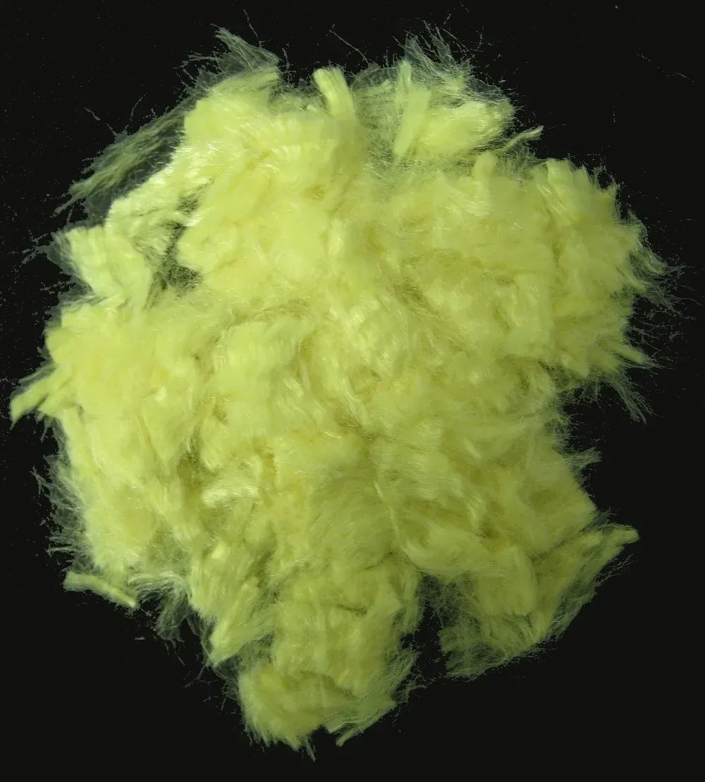A dense clump of fine, bright yellow-green fibers cut short and photographed in close-up against a black background.