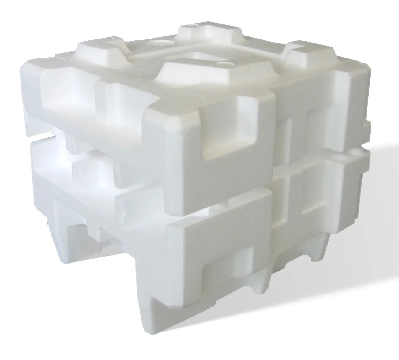 A block of white expanded polystyrene foam, molded into interlocking ridges and recesses shaped to cradle another object during shipping.
