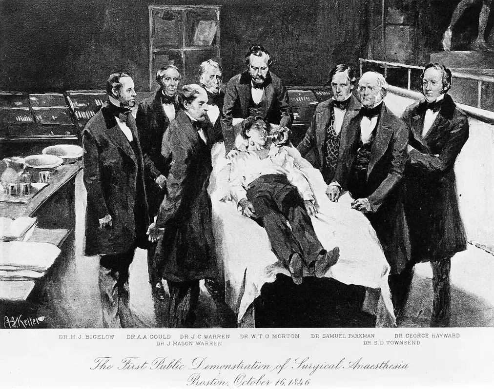 A monochrome print titled 'The First Public Demonstration of Surgical Anaesthesia,' showing a crowded operating theatre in which a patient reclines on a table while a ring of surgeons in dark formal coats look on.