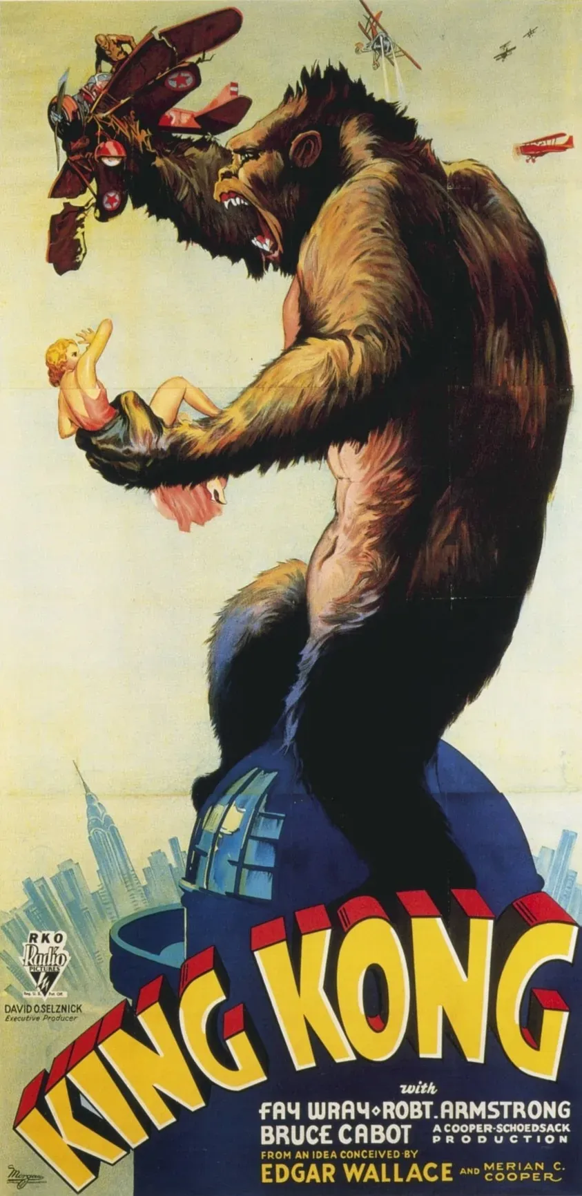 Illustrated 1933 movie poster showing a giant ape clutching a woman atop a building, swatting at biplanes, with the New York skyline below.