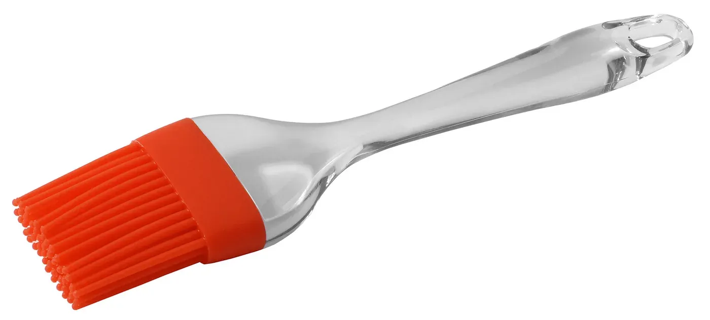 A kitchen basting brush with an orange silicone bristle head and a clear molded silicone handle, photographed against a white background.