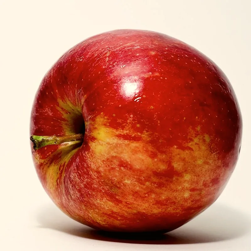 A single whole red apple on a plain background