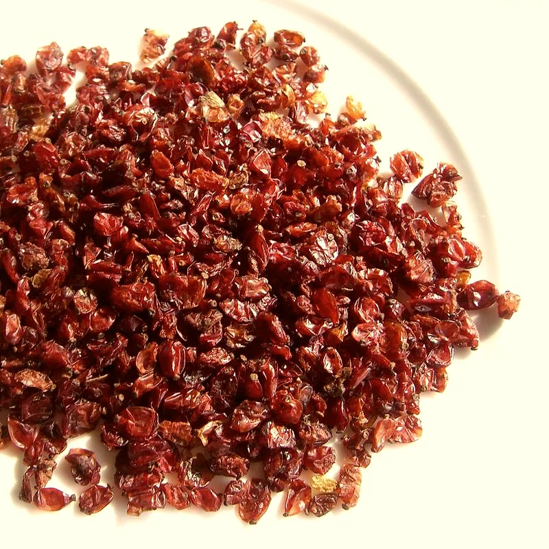 A pile of small, dried red barberries on a plate