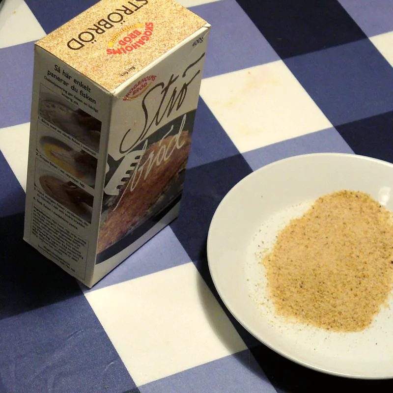 A plate of loose, fine golden-brown dried breadcrumbs