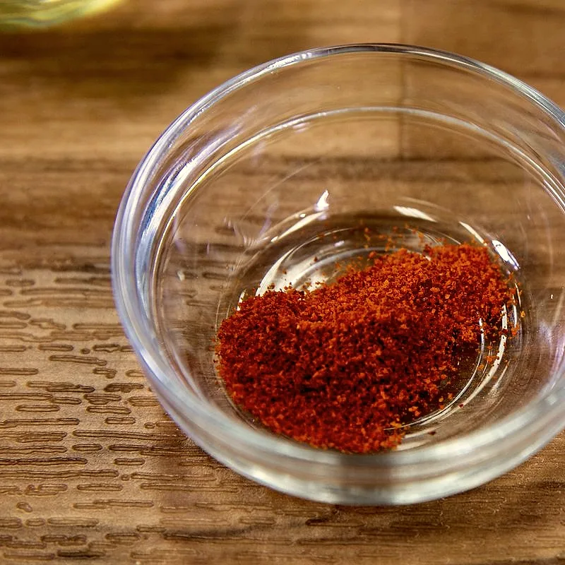 A small bowl of fine red cayenne pepper powder