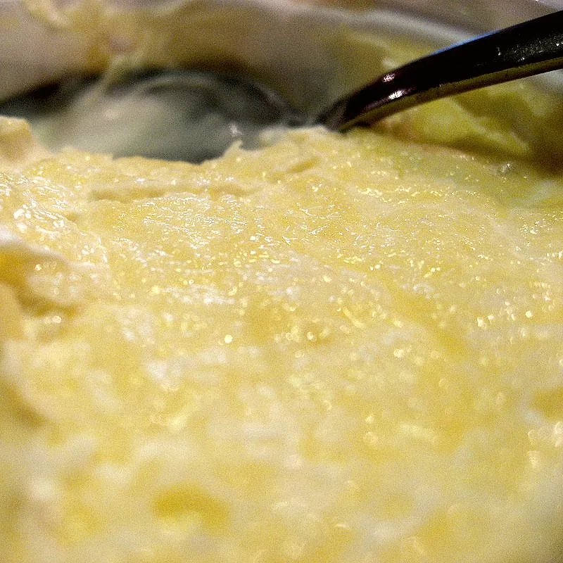 A close view of thick, pale yellow clotted cream with its characteristic crusted surface