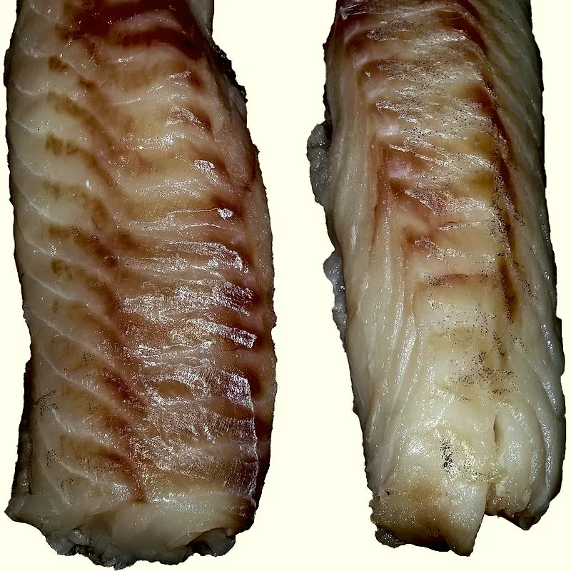 Two raw cod fillets, pale flesh with visible flake lines