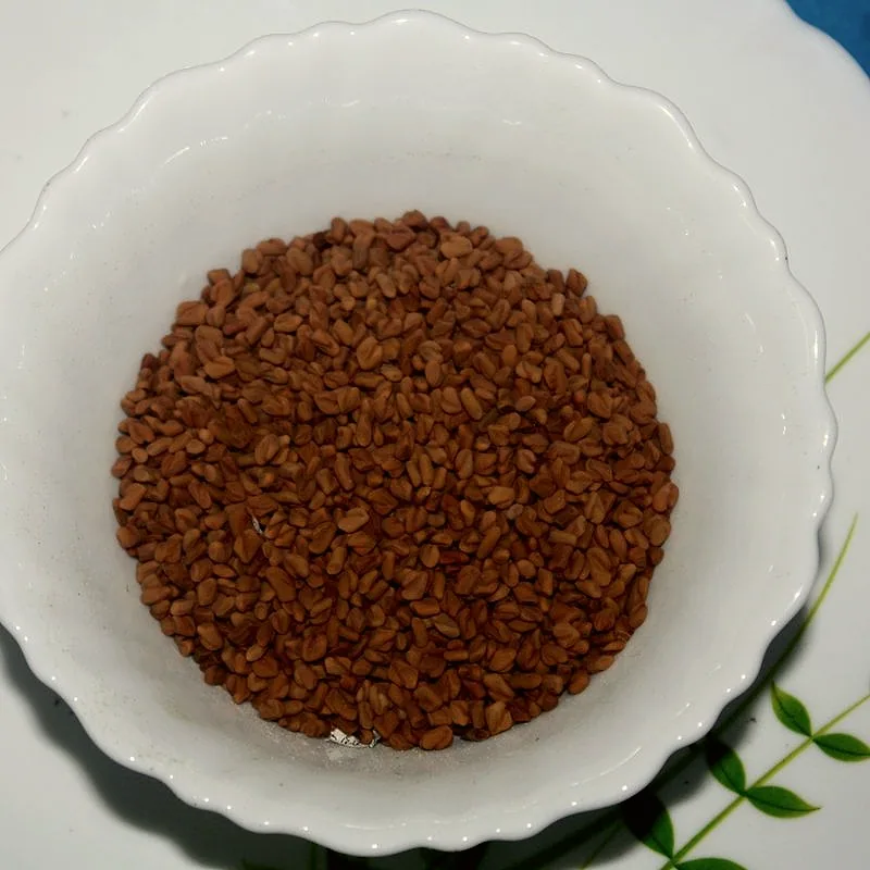 A bowl of small angular brown fenugreek seeds