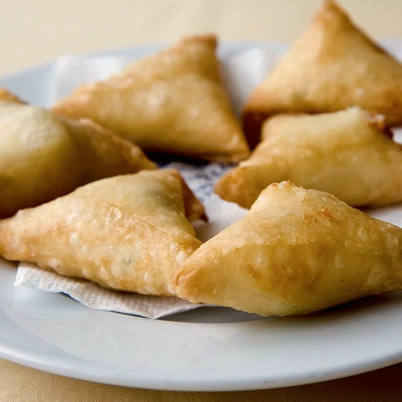 A thin, translucent sheet of filo-style pastry being folded