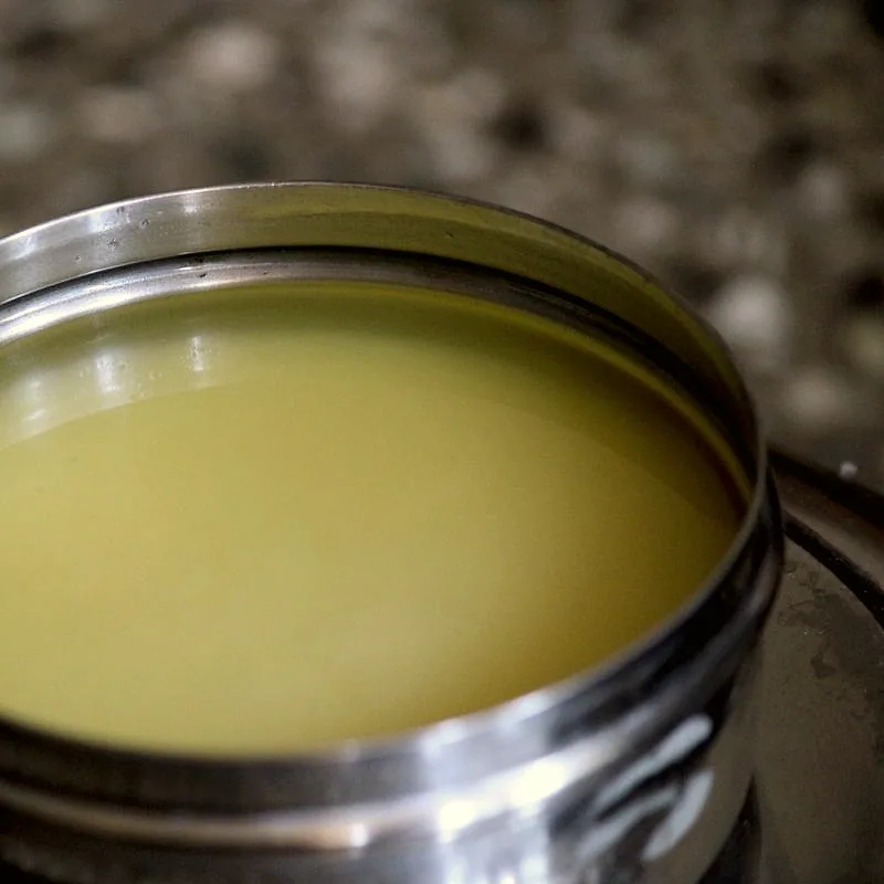 Golden liquid ghee in a steel container