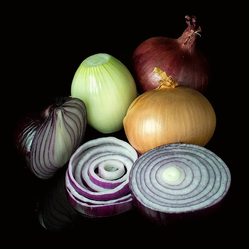 Red, white and brown onions, some halved to show their rings