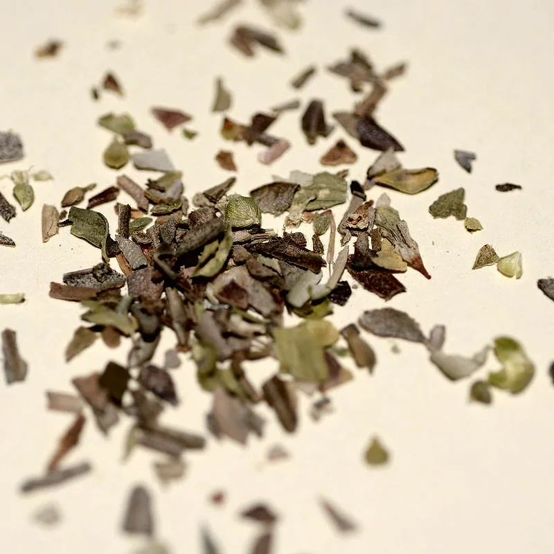A scattered pile of dried oregano leaves