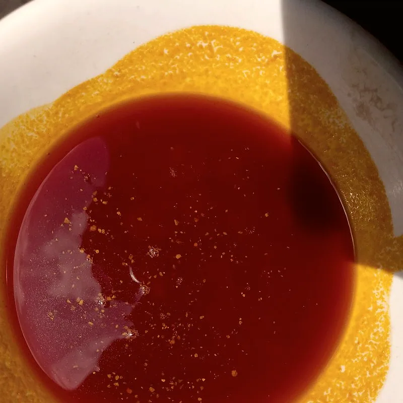 Deep red palm oil in a white bowl