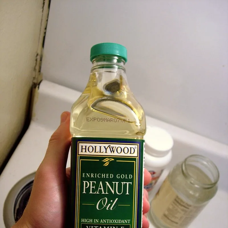 A bottle of pale golden peanut oil