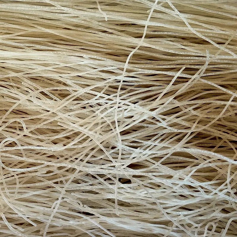 A loose mass of dried white rice noodles