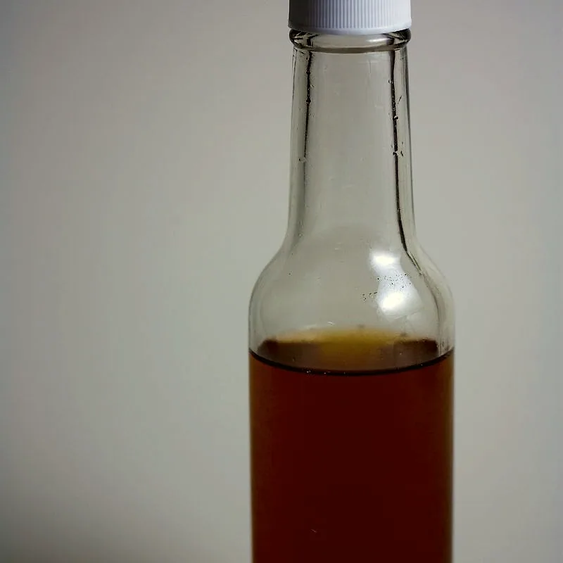 A tall bottle of dark brown vanilla extract