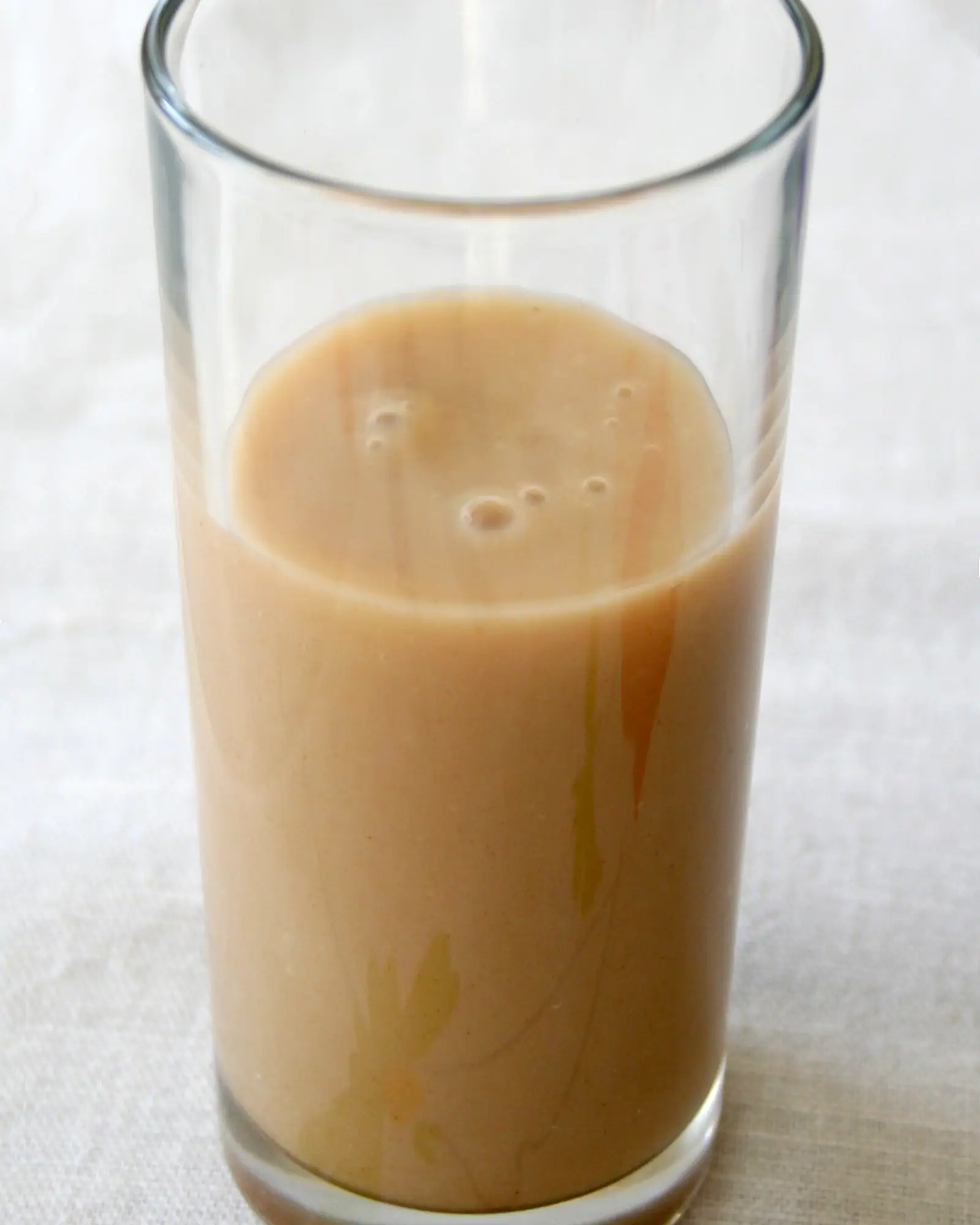 Tan, thick boza filling a tall glass