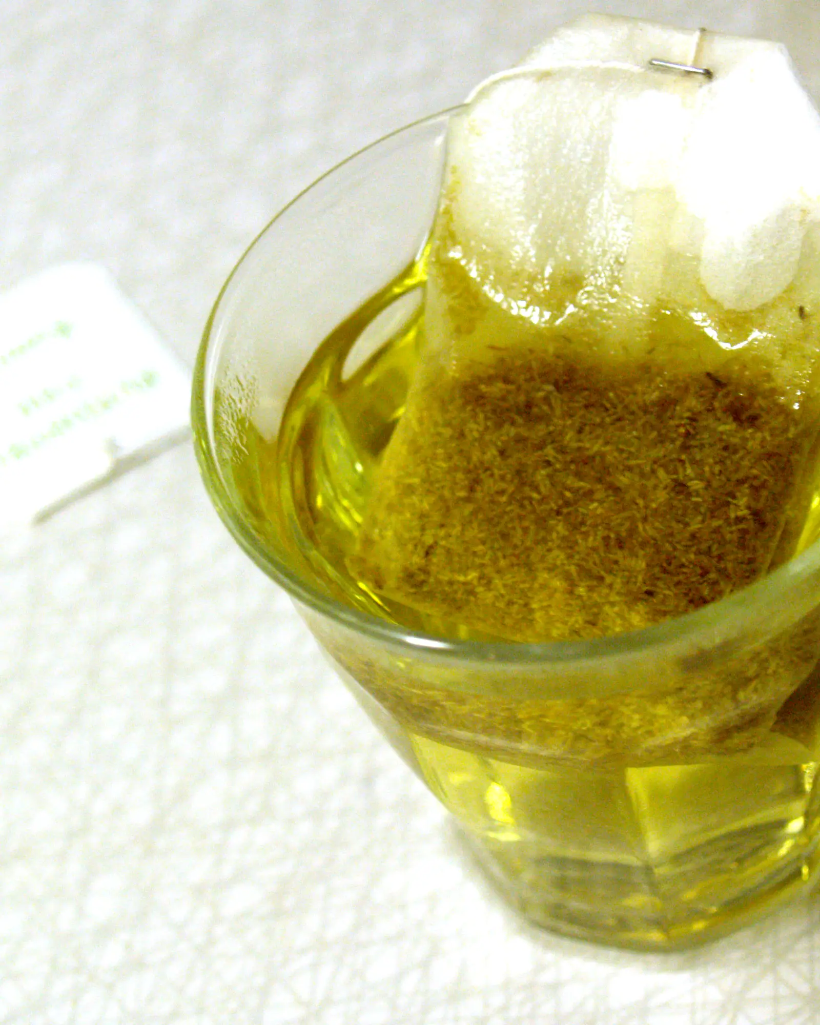 A glass cup of pale golden chamomile tea