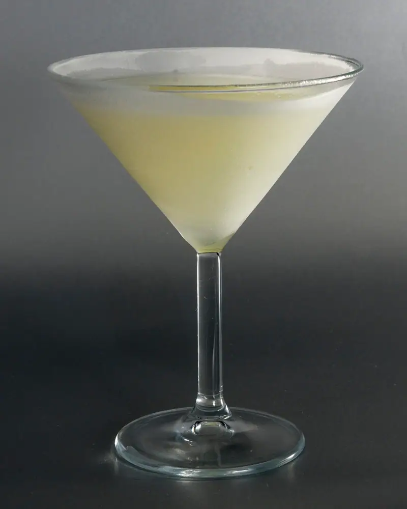 A pale yellow-green Last Word cocktail served up in a martini glass