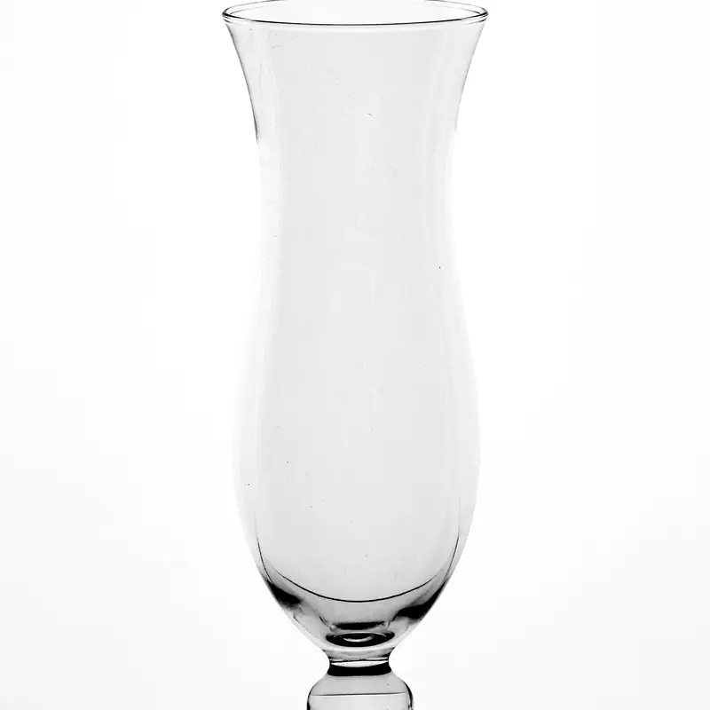 An empty hurricane glass on a white background, showing its tall curved silhouette narrowing at the waist above a short stem and round foot