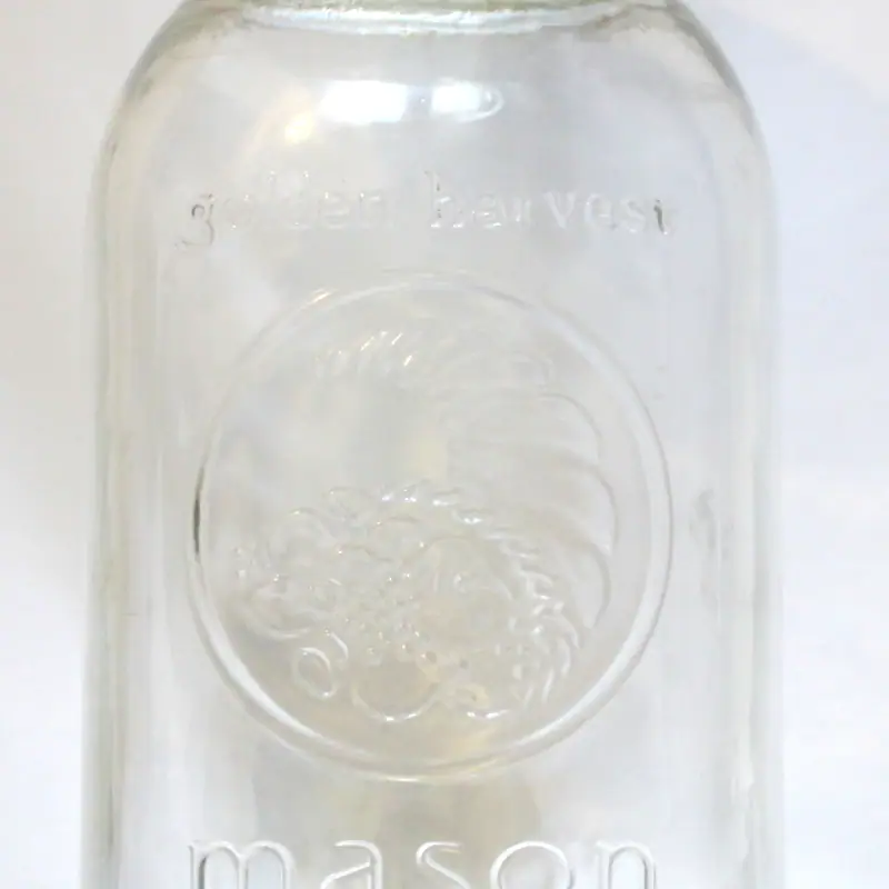 An empty glass mason jar with a screw-top lid