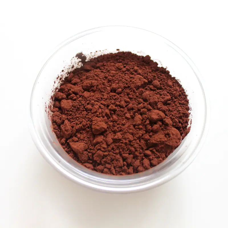 A small bowl of dark, dry cocoa powder