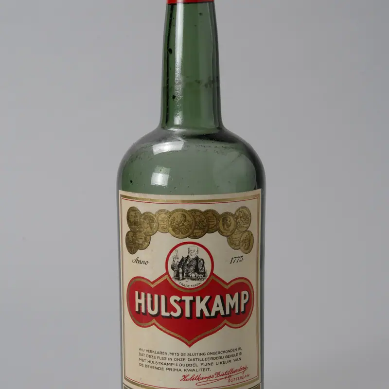 A bottle of Hulstkamp Crème de Cacao, green glass with a cream and red label