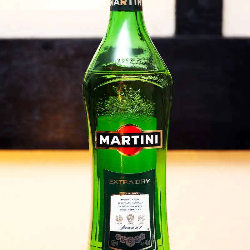 A green glass bottle of Martini Extra Dry vermouth