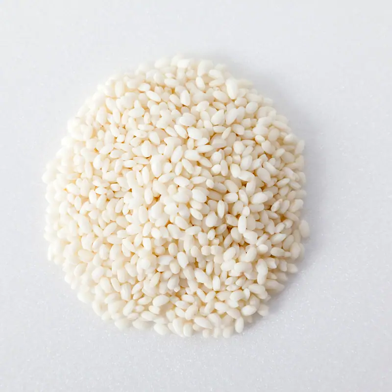 A pile of uncooked glutinous (sticky) rice, short opaque white grains