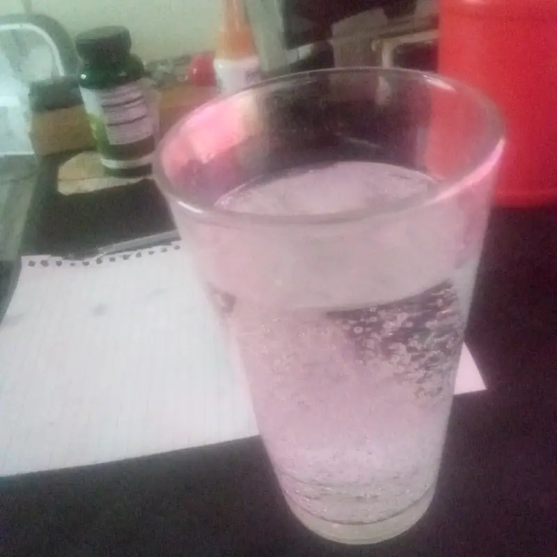 Clear, carbonated lemon-lime soda in a plain glass