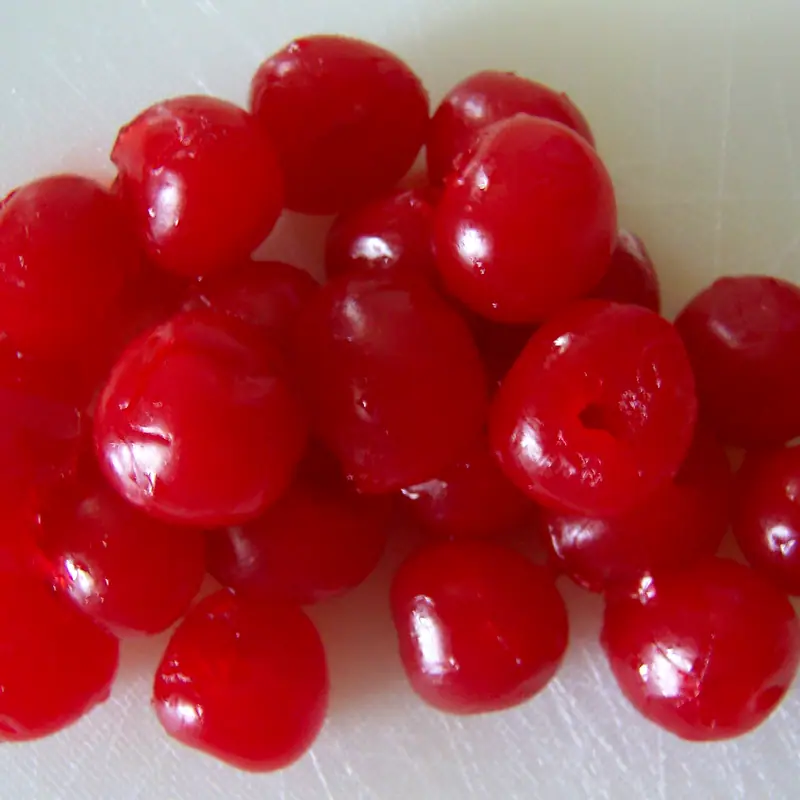 A heap of glossy red maraschino cherries